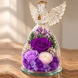 Close view of the purple flowers and feather-wing glass angel
