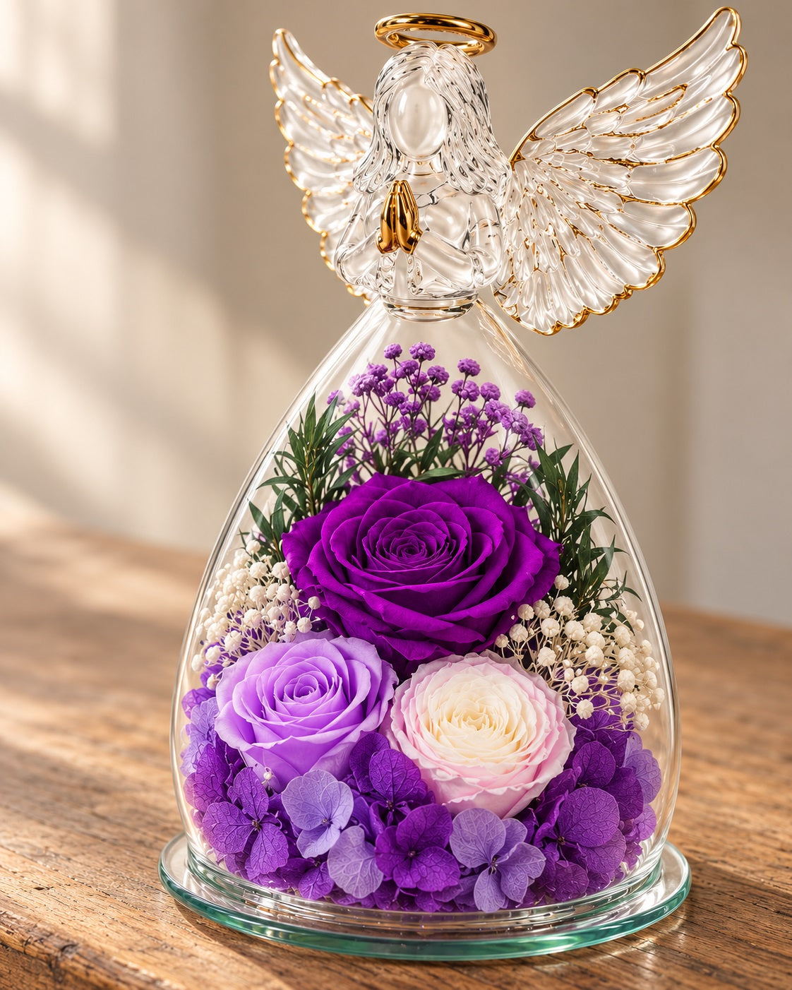 Close view of the purple flowers and feather-wing glass angel