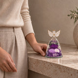 Compact Purple Angel Wings Keepsake beside a seated person for scale