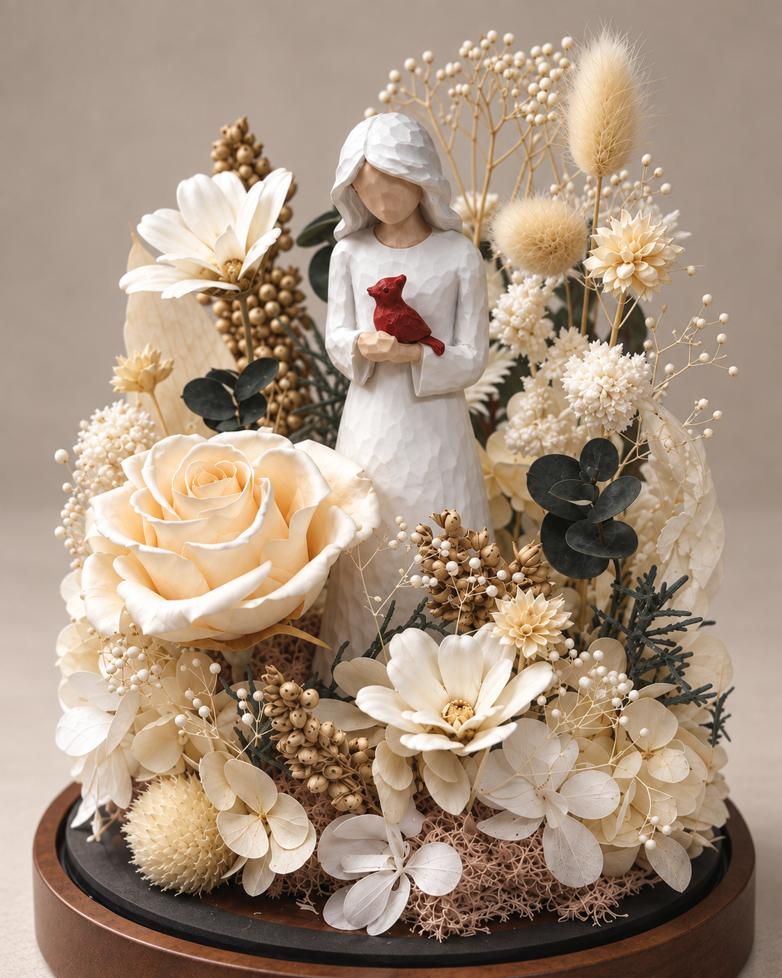 Close detail of the cardinal figurine and preserved flowers