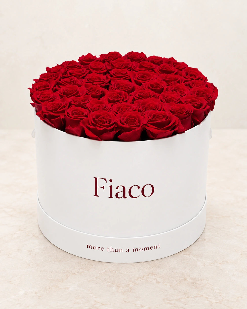 Fiaco Embrace Rose Cylinder front view with deep red roses and more than a moment on the base