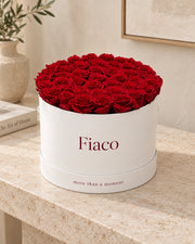 Fiaco Embrace Rose Cylinder displayed on a stone console in a home