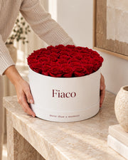 Hands placing the Fiaco Embrace Rose Cylinder for scale